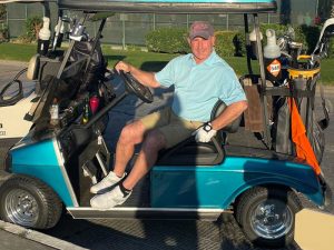 Steve Finkelstein sitting in a golf cart.