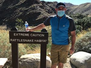 Steve Finkelstein standing near rattlesnake habitat.