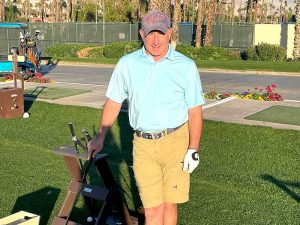 Steve Finkelstein holding a club waiting to play golf.