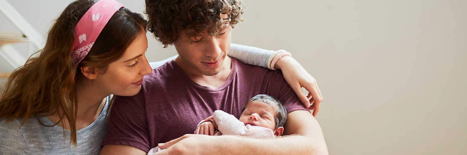 Young couple holding their newborn baby.